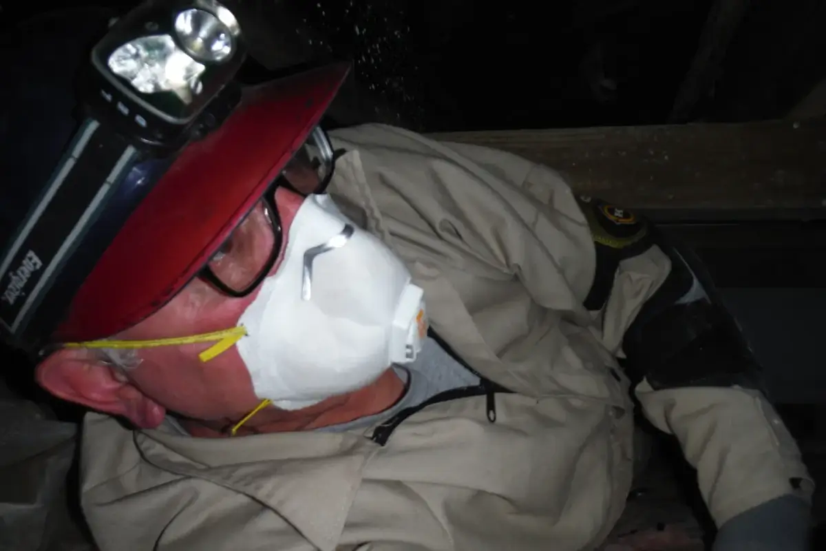 A man wearing a white mask and red hat.
