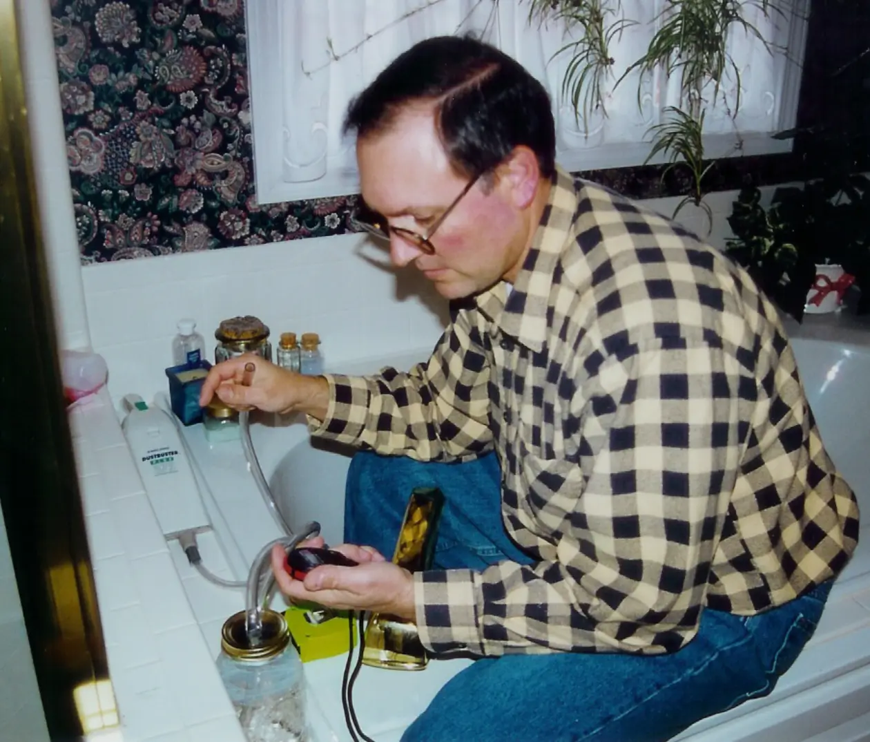 A man sitting on the edge of a bathtub.