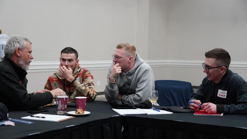 Two men sitting at a table with drinks.