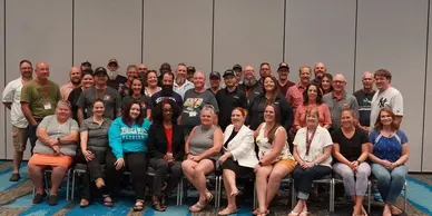A group of people sitting in front of each other.